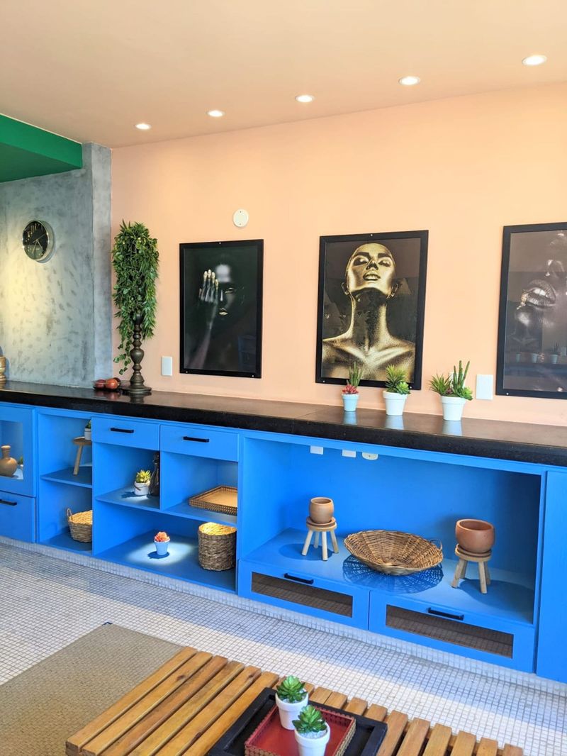 Blue sideboard shelves under framed prints