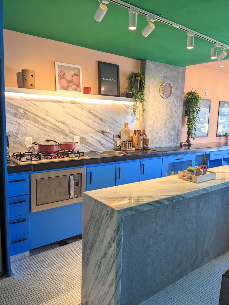 The kitchen with its marble-clad island and track lighting