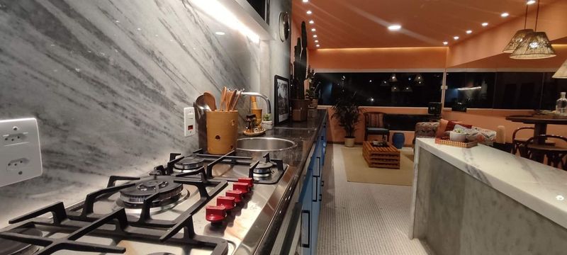 The gas hob and marble backsplash, with the living room beyond