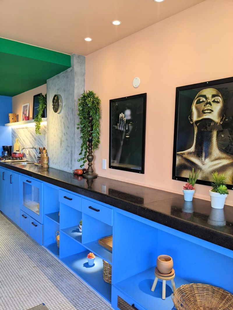 Blue cabinets under framed prints