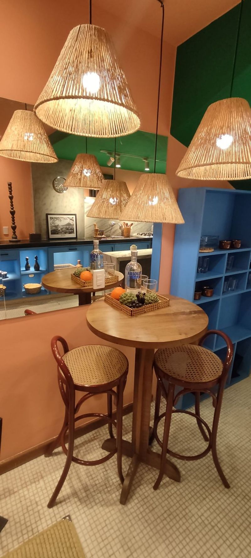 A dining corner under woven pendant lamps