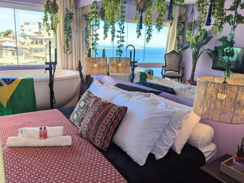The bedroom, with the tub by the window and the sea beyond