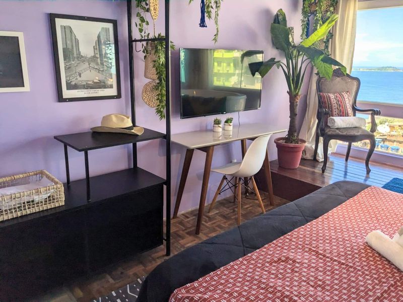The bedroom desk, wall TV and clothes rail