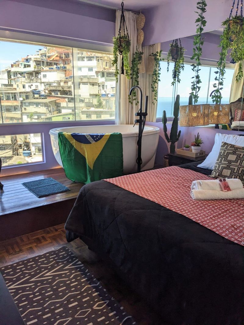 The bed and the tub by the window over the houses