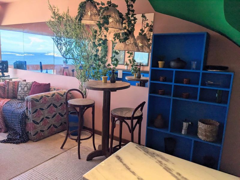 The sofa, a high table and the blue shelving