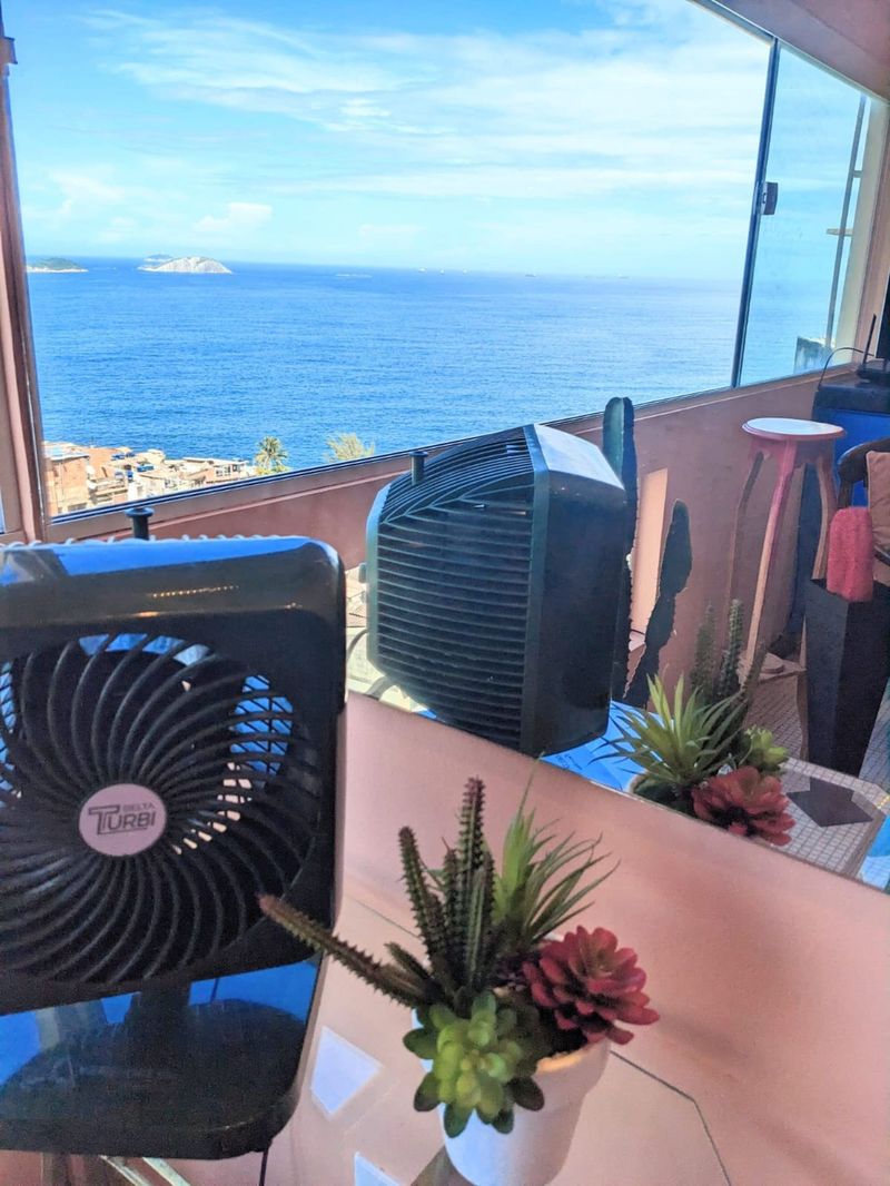 A fan at the window over the ocean