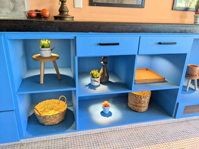 Blue shelving with baskets and plants