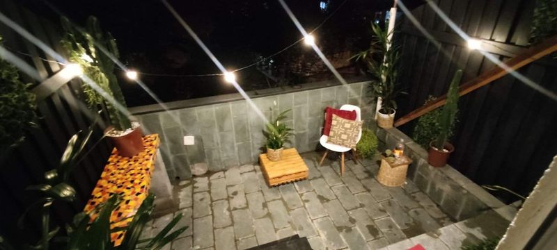 The terrace at night under string lights