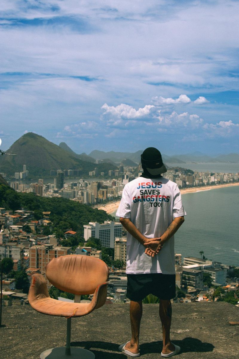 A man on a rooftop looking out over Leblon and Ipanema