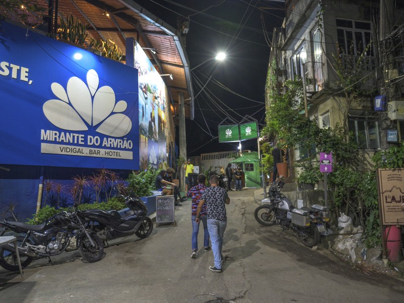 The street entrance to Mirante do Arvrão at night, with parked motorbikes